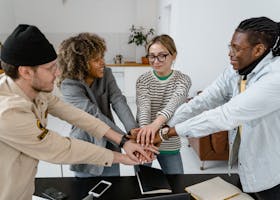 A diverse group of office co-workers sharing a team bonding moment.